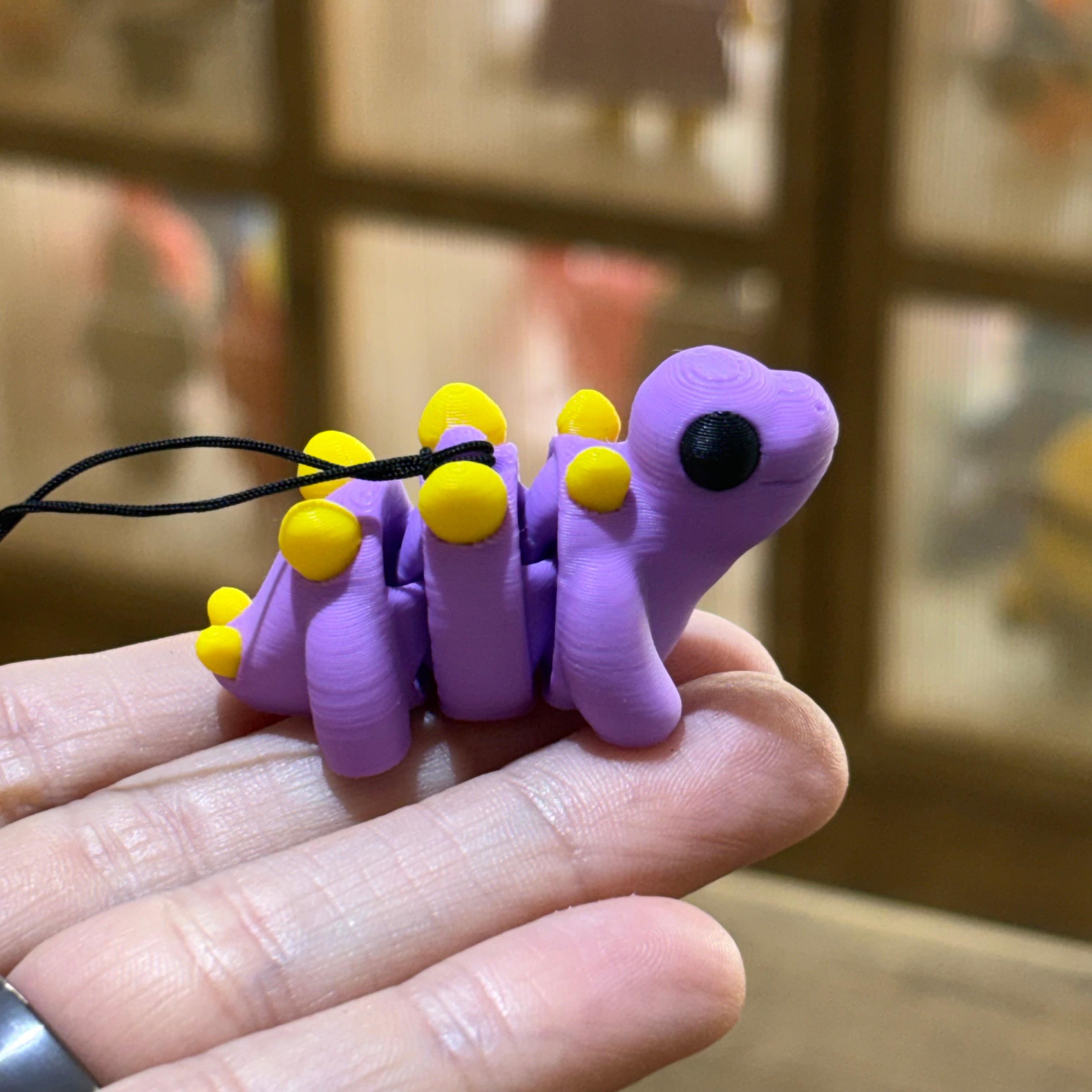 LLAVERO MINI STEGOSAURUS FLEXI LILA