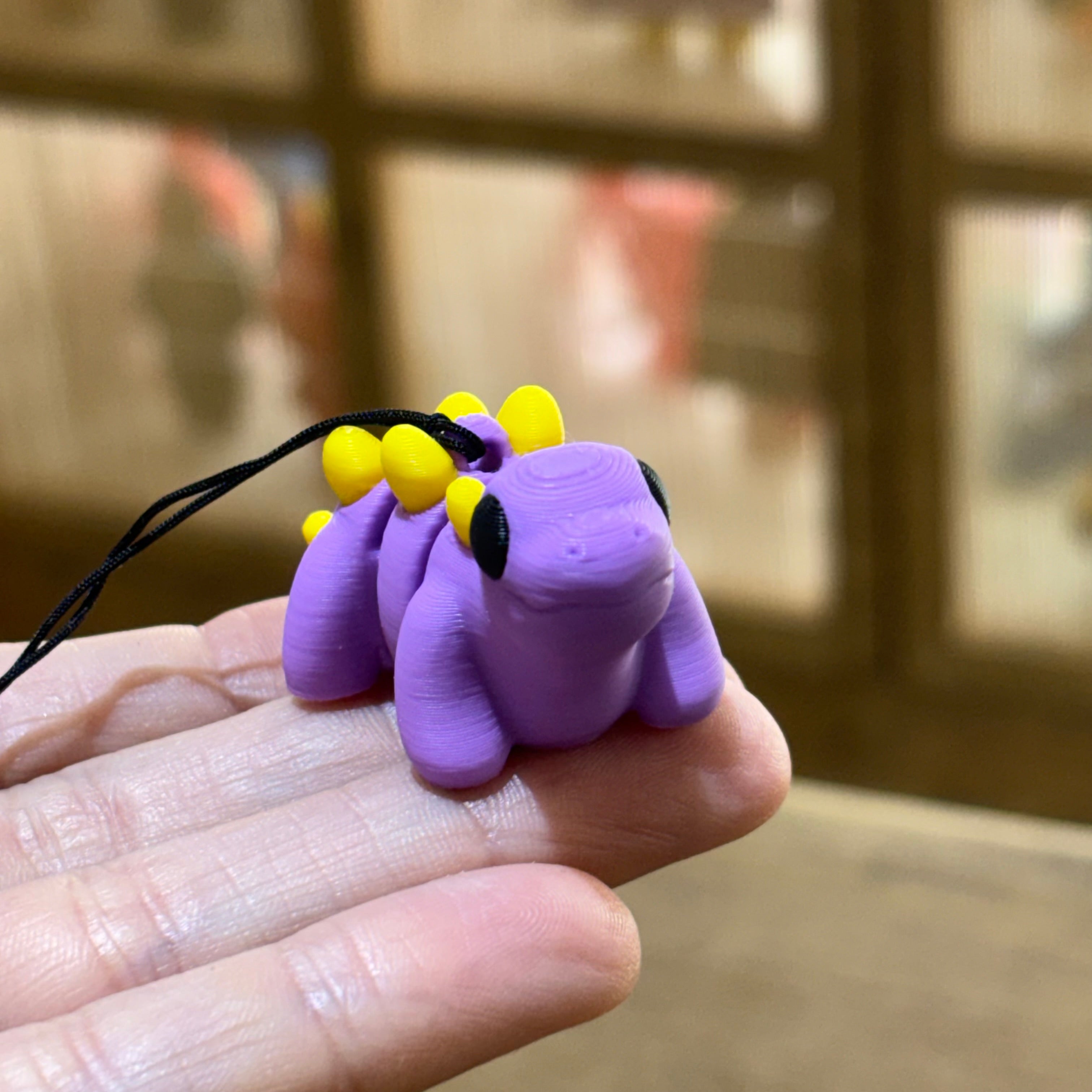 LLAVERO MINI STEGOSAURUS FLEXI LILA